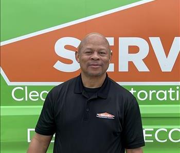 SERVPRO Employee with a green background